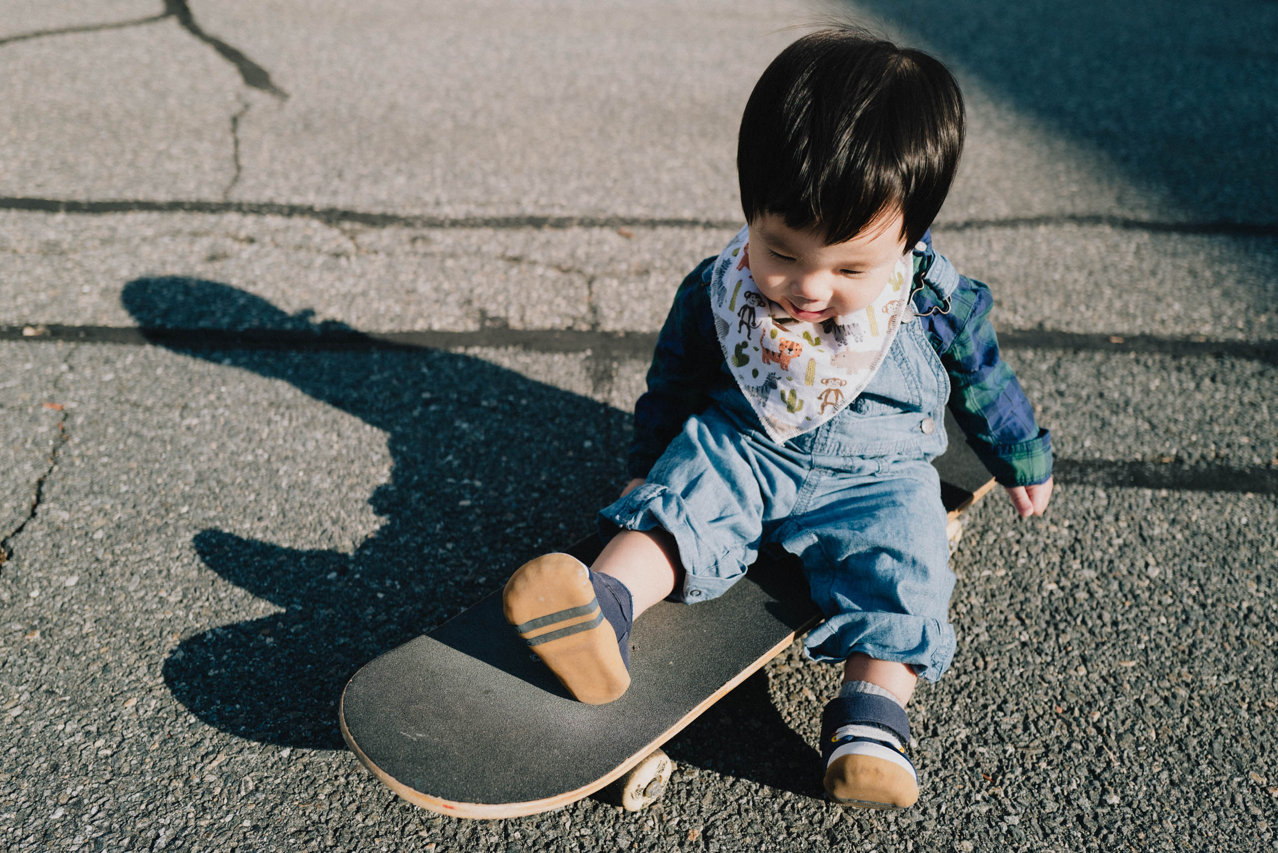 Baby J on a skateboard.