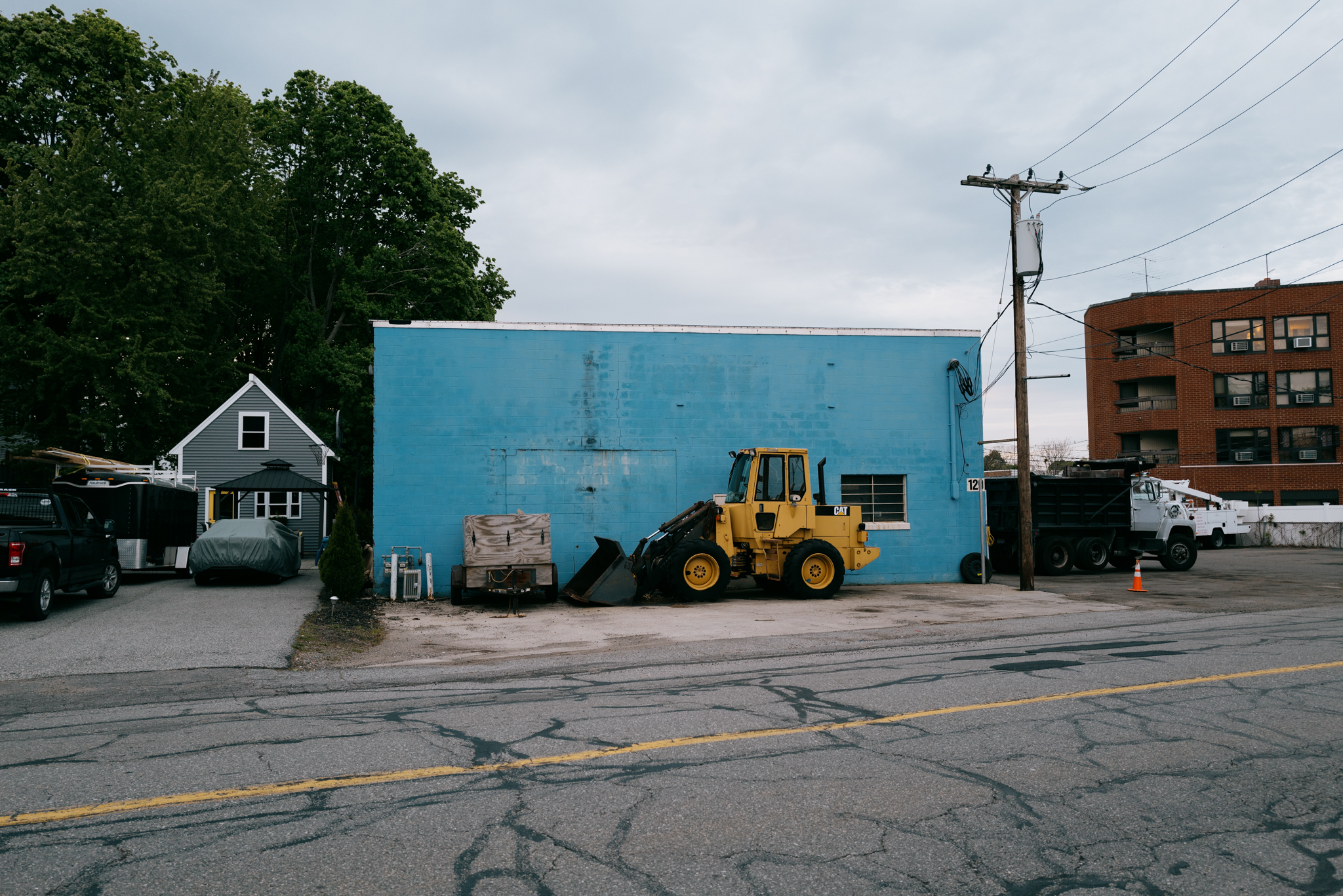 A bulldozer in a parking lot. Image captured with a Leica Q2