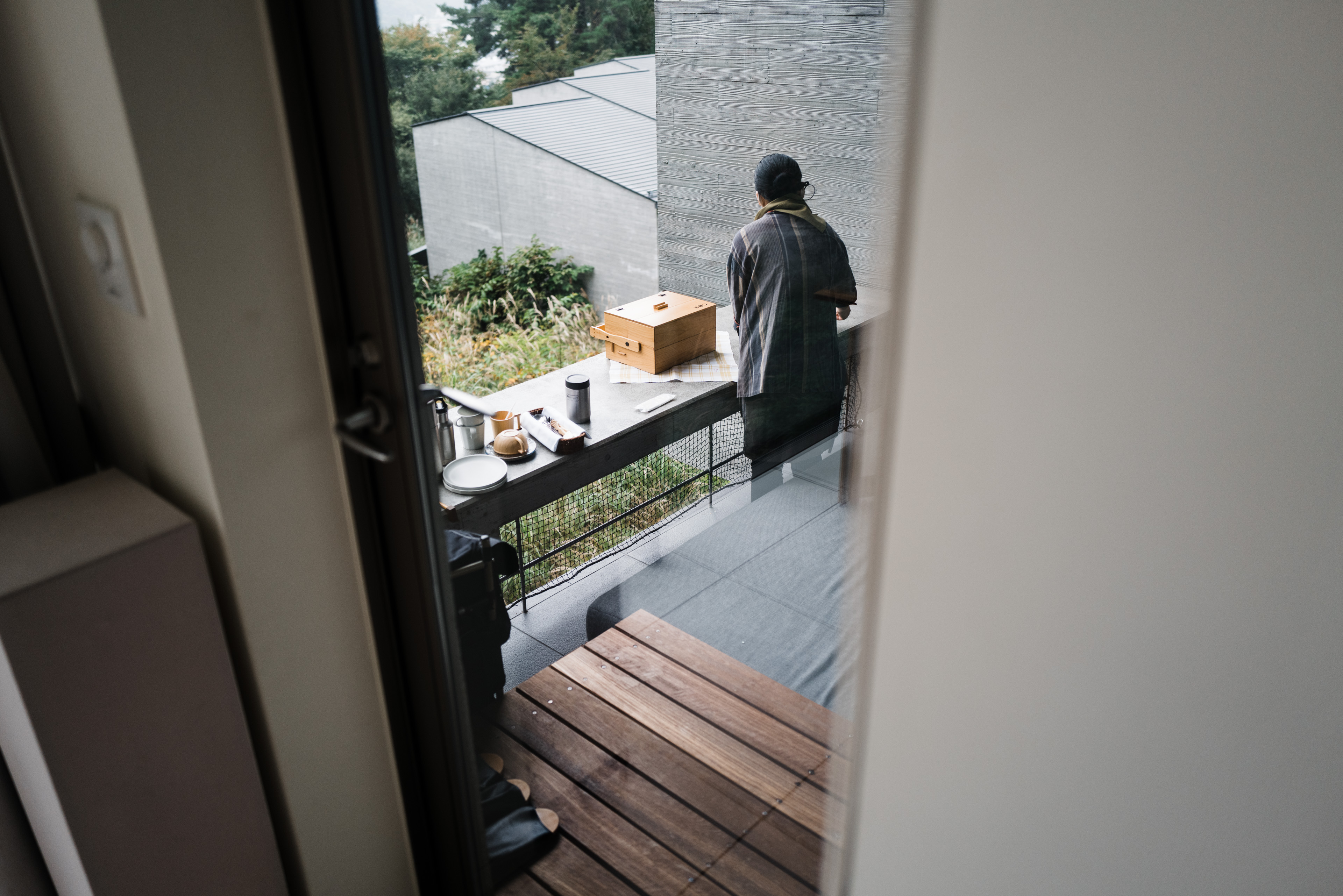 A Hoshinoya staff member setting up our breakfast on the balcony.